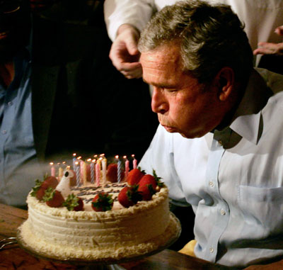 former us president george w bush blows out candles on his 60th birthday photo reuters