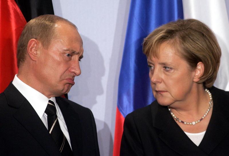 russian president vladmir putin engrossed in a conversation with german counselor angela merkel photo reuters