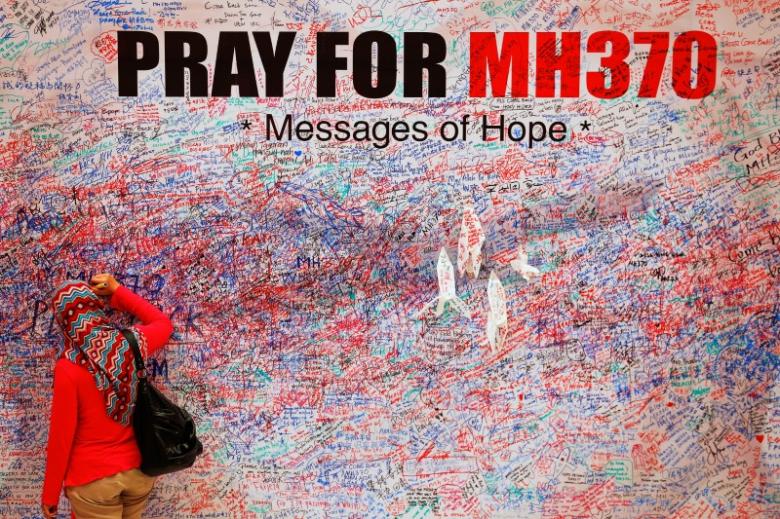 file photo a woman leaves a message of support and hope for the passengers of the missing malaysia airlines mh370 in central kuala lumpur march 16 2014 photo reuters