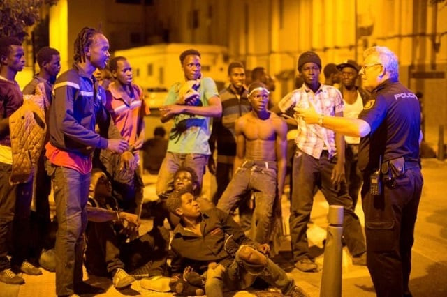 african migrants listen to a police officer after crossing the border from morocco to spain 039 s north african enclave of ceuta spain early august 1 2017 photo reuters african migrants listen to a police officer after crossing the border from morocco to spain 039 s north african enclave of ceuta spain early august 1 2017 photo reuters