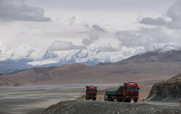 trucks driving along the china pakistan friendship highway before the karakorum mountain range near tashkurgan in china 039 s western xinjiang province photo afp trucks driving along the china pakistan friendship highway before the karakorum mountain range near tashkurgan in china 039 s western xinjiang province photo afp