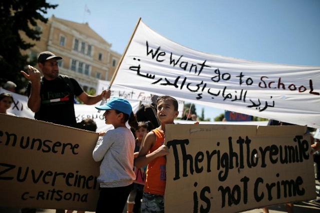 syrian refugee children hold banners and shout during a demonstration against delays in reunifications of refugee families from greece to germany in athens greece august 2 2017 photo reuters