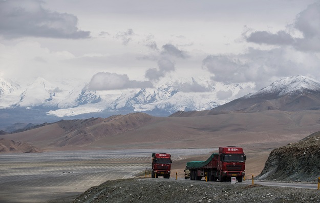 trucks driving along the china pakistan friendship highway before the karakorum mountain range near tashkurgan in china 039 s western xinjiang province photo afp