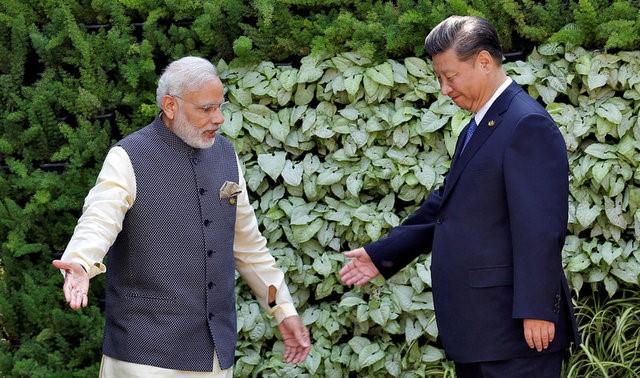 indian prime minister narendra modi l and chinese president xi jinping leave after a group picture during brics brazil russia india china and south africa summit in benaulim in the western state of goa india photo reuters file