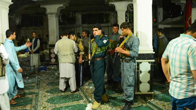 afghan security personnel inspect the site after the suicide bomb attack at a shia mosque in herat photo afp