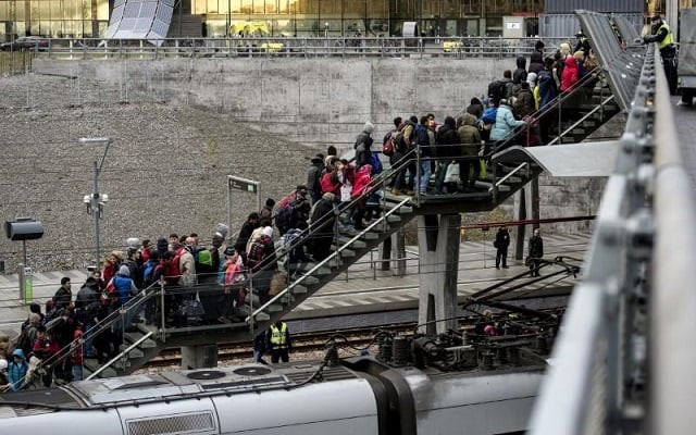 police organize a line of refugees on a stairway leading up to trains arriving from denmark at the hyllie train station outside malmo sweden november 19 2015 photo reuters police organize a line of refugees on a stairway leading up to trains arriving from denmark at the hyllie train station outside malmo sweden november 19 2015 photo reuters