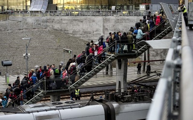 police organize a line of refugees on a stairway leading up to trains arriving from denmark at the hyllie train station outside malmo sweden november 19 2015 photo reuters