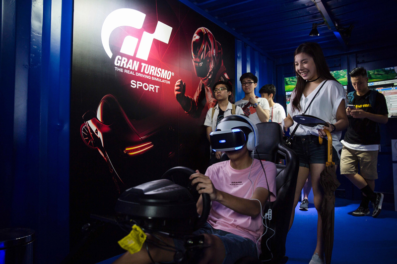 a gamer c plays a driving console game during the esports and music festival in hong kong on august 4 2017 photo afp