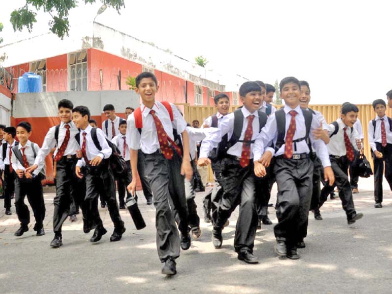 schoolboys returning home on the first day of school after the summer vacations photo inp