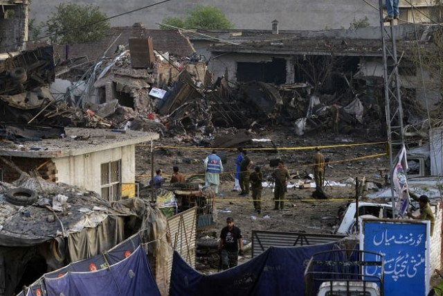 security officials investigate the site following an overnight bomb explosion placed inside a truck in lahore on august 8 2017 security officials investigate the site following an overnight bomb explosion placed inside a truck in lahore on august 8 2017