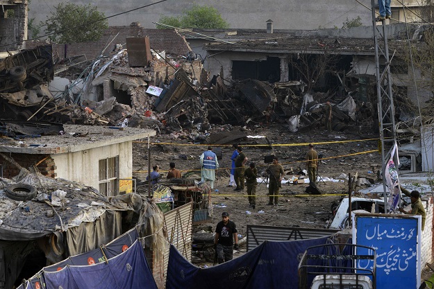 security officials investigate the site following an overnight bomb explosion placed inside a truck in lahore on august 8 2017