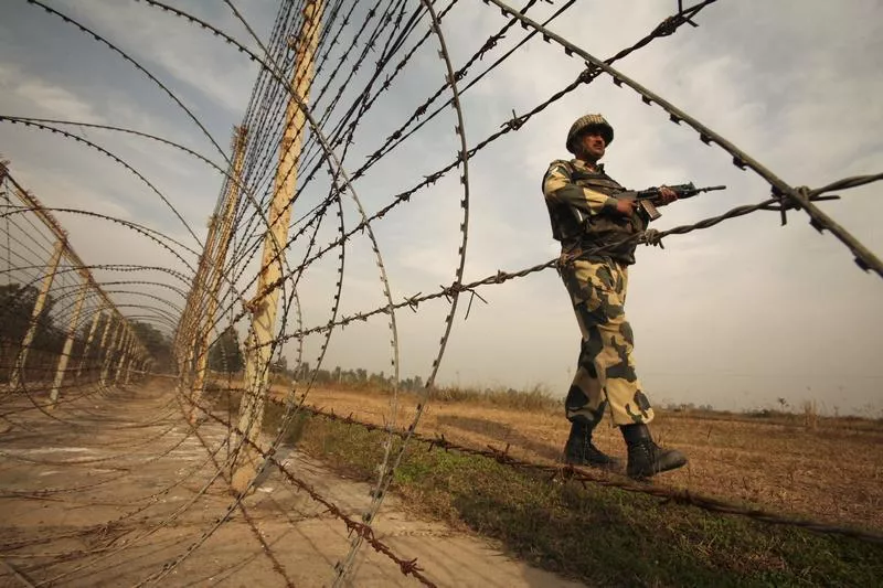 an indian border security force bsf soldier patrols near the fenced border with pakistan photo reuters an indian border security force bsf soldier patrols near the fenced border with pakistan photo reuters