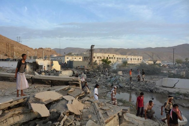people inspect damage at a site hit by saudi led air strikes in the al qaeda held port of mukalla city in southern yemen april 24 2016 photo reuters