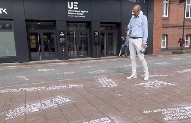 a man takes pictures of quot hate tweets quot a part of the art project quot heytwitter quot created by shahak shapira outside twitter office in hamburg germany august 4 2017 in this picture obtained from social media youtube via reuters