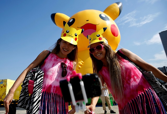 women take a selfie in front of a large pikachu figure at a pokemon go park event in yokohama japan august 9 2017 photo reuters