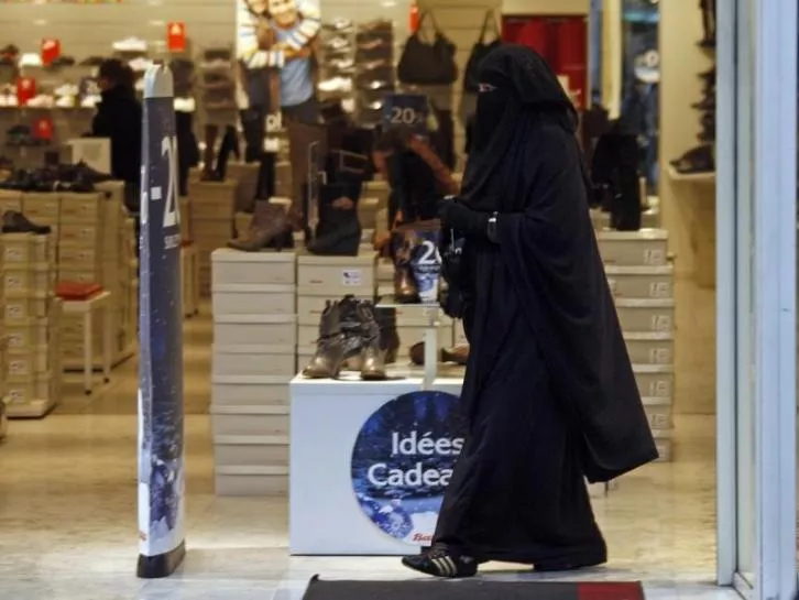 a woman wearing a burqa exits a shop on the street in marseille photo reuters
