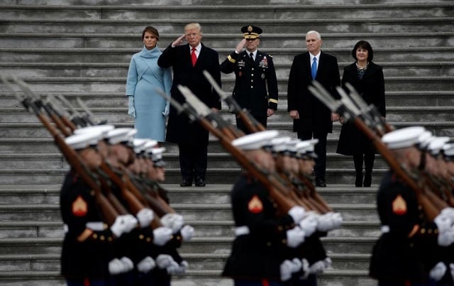 newly inaugurated u s president donald trump in red tie first lady melania l vice president mike pence and his wife karen r preside over a military parade during trump 039 s swearing ceremony in washington u s january 20 2017 photo reuters