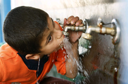 a child drinking water from the tap photo reuters