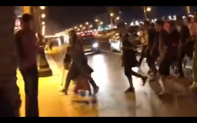 this screengrab shows a woman running across the street and a mob of men following her photo screengrab this screengrab shows a woman running across the street and a mob of men following her photo screengrab