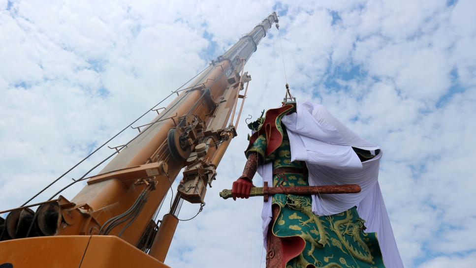a crane is used to cover the statue of guan yu a chinese deity with a cloth in tuban about 100 km 60 miles west of indonesia 039 s second biggest city of surabaya east java indonesia august 6 2017 in this photo taken by antara foto picture taken august 6 2017 photo reuters