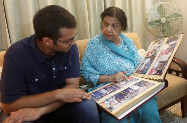 rehana khursheed hashmi 75 migrated from india with her family in 1960 and whose relatives live in india speaks with her grandson zain hashmi 19 while looking at family photo albums in karachi photo reuters