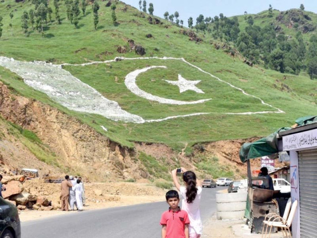 a flag painted on a hill an illuminated mosque in peshawar and a stall of flags in attock speak of national spirit ahead of independence day photo agencies a flag painted on a hill an illuminated mosque in peshawar and a stall of flags in attock speak of national spirit ahead of independence day photo agencies