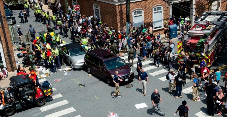 people receive first aid after a car ran into a crowd of protesters in charlottesville virginia on august 12 2017 photo afp