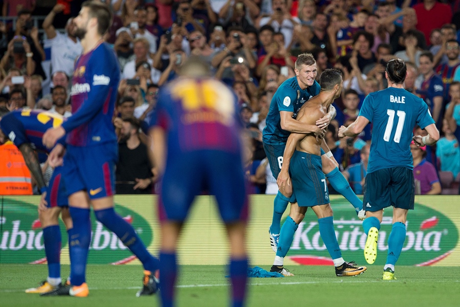 real madrid 039 s portuguese forward cristiano ronaldo 2r celebrates a goal with teammate real madrid 039 s german midfielder toni kroos 3r during the first leg of the spanish supercup football match between fc barcelona and real madrid at the camp nou stadium in barcelona on august 13 2017 photo afp