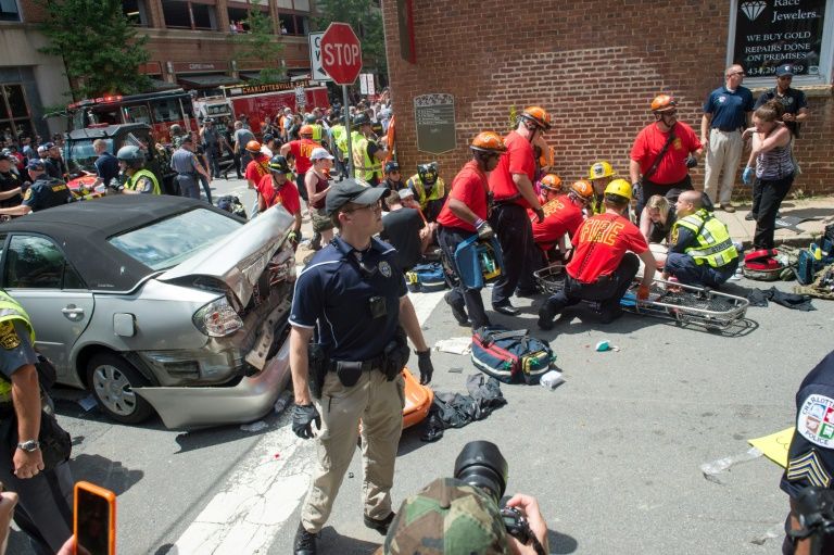 a woman receives first aid after a car plowed into a crowd in charlottesville virginia on saturday after a rally by white nationalists turned violent photo afp