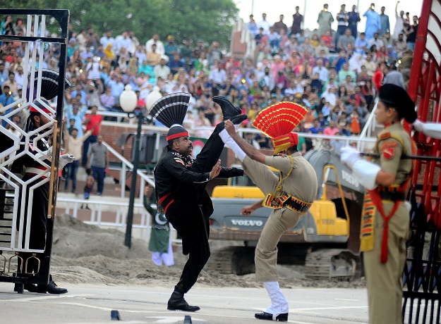 indian and pakistani border guards take part in the nightly ceremony at the india pakistan border in wagah photo afp