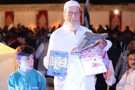 an elderly man struggles to hold on to the prizes he won during mtma 039 s recent annual event photo courtesy mtma an elderly man struggles to hold on to the prizes he won during mtma 039 s recent annual event photo courtesy mtma