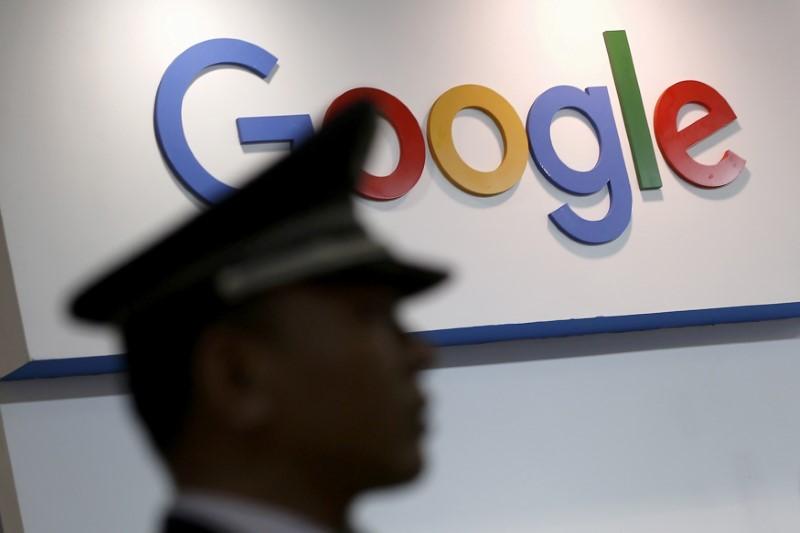 file photo a security guard keeps watch as he walks past a logo of google in shanghai china april 21 2016 reuters aly song file photo   rts1accz