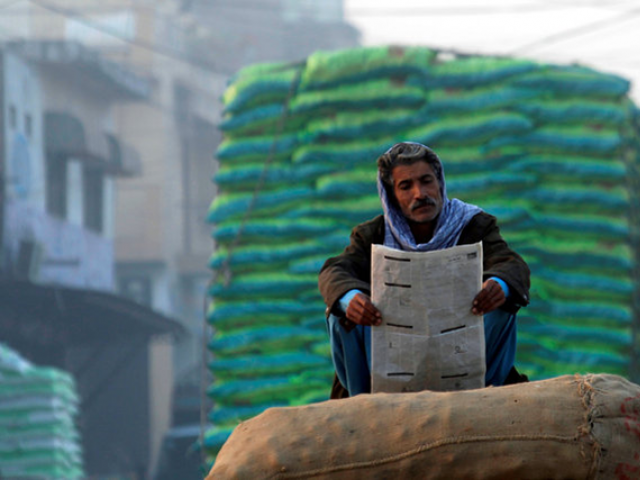 a man reads newspaper in the morning photo reuters