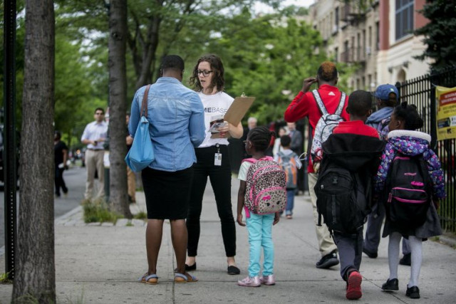 ms amelia watts of new york city s human resources administration talking to a parent outside of a school in brooklyn as part of a programme aimed at preventing families from becoming homeless photo nytimes