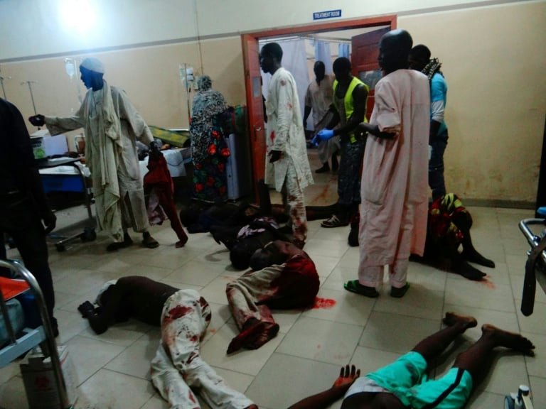 injured victims of a female suicide bomber lie on the floor awaiting medical attention as beds were no longer available at a maiduguri hospital in northeastern nigeria photo afp