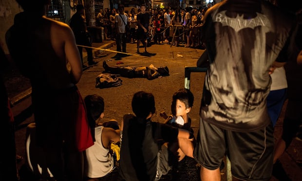 residents surround the body of an alleged drug user killed in manila photo afp