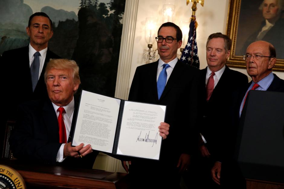 u s president donald trump flanked by u s representative darrell issa r ca l treasury secretary steven mnuchin 3rd r u s trade representative robert lighthizer 2nd r and commerce secretary wilbur ross r finishes signing a memorandum directing the u s trade representative to complete a review of trade issues with china at the white house in washington u s august 14 2017 reuters jonathan ernst