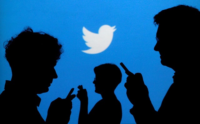 file photo people holding mobile phones are silhouetted against a backdrop projected with the twitter logo in this illustration picture taken september 27 2013 reuters kacper pempel illustration file photo