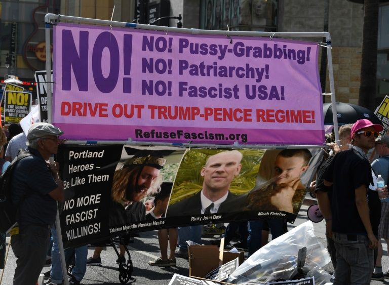 demonstrators hold a banner at an anti trump protest in california a state which has been at loggerheads with president donald trump 039 s administration over various issues photo afp