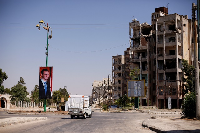 a picture of syria 039 s president bashar al assad is seen in waer district in the central syrian city of homs syria july 26 2017 picture taken july 26 2017 photo reuters