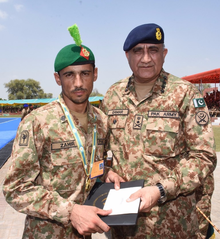 army chief gen qamar javed bajwa poses with sepoy zahir shah who wins the overall best player award at the 6th army paces championship photo ispr