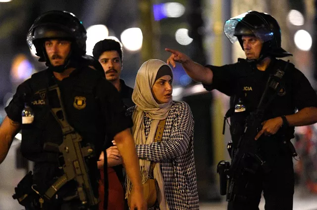 spanish policemen accompany clients of a store outside a cordoned off area after a van ploughed into the crowd killing 13 persons and injuring over 80 on the rambla in barcelona photo afp spanish policemen accompany clients of a store outside a cordoned off area after a van ploughed into the crowd killing 13 persons and injuring over 80 on the rambla in barcelona photo afp