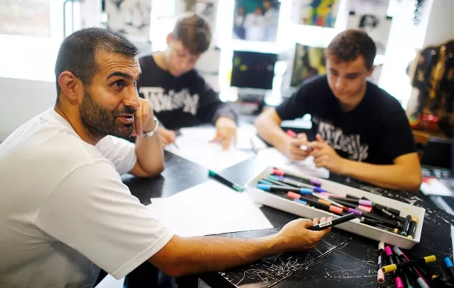 graffiti artist ibo omari gives an interview in his shop in berlin germany august 18 2017 photo reuters graffiti artist ibo omari gives an interview in his shop in berlin germany august 18 2017 photo reuters
