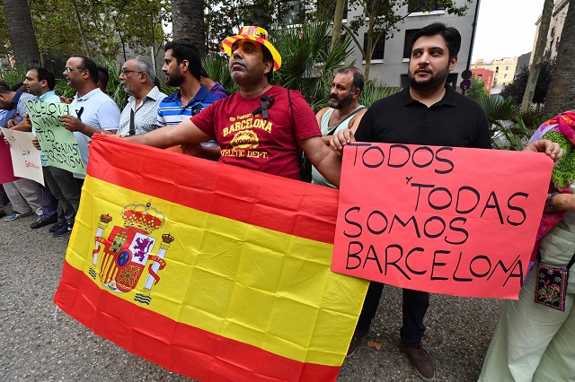 members of the pakistani community living in barcelona gather on the la rambla del rabal in barcelona against the attacks and in tribute to the victims of the barcelona attack photo afp