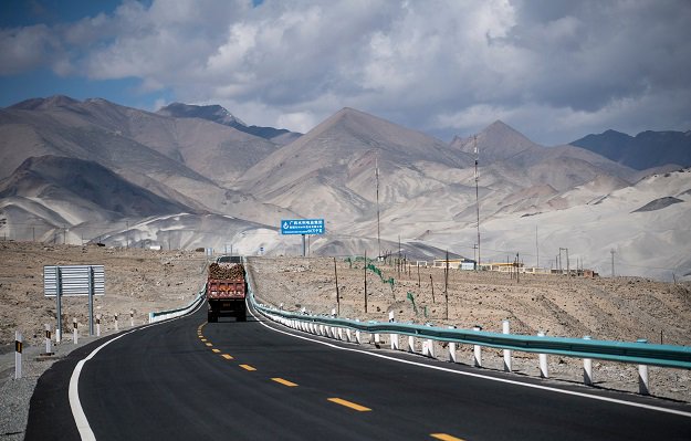 a truck drives along the china pakistan friendship highway before the karakorum mountain range near tashkurgan in china 039 s western xinjiang province photo afp