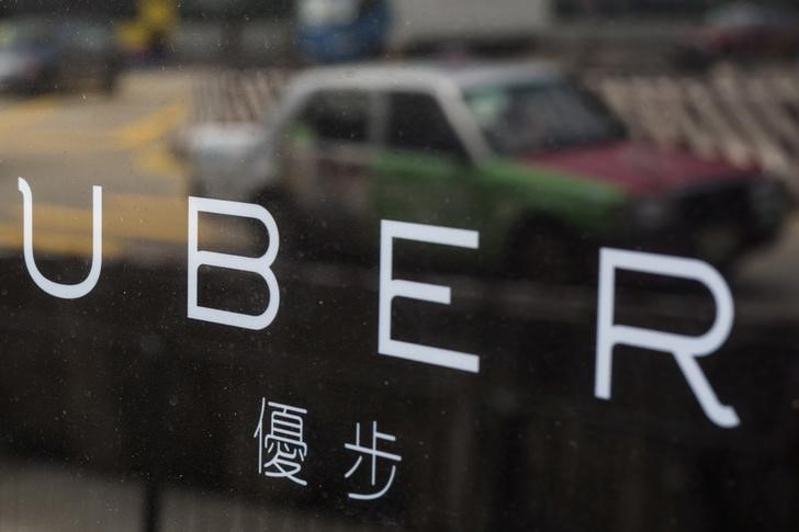 file photo   a taxi is reflected in a window at the office of taxi hailing service uber inc in hong kong china august 12 2015 photo reuters