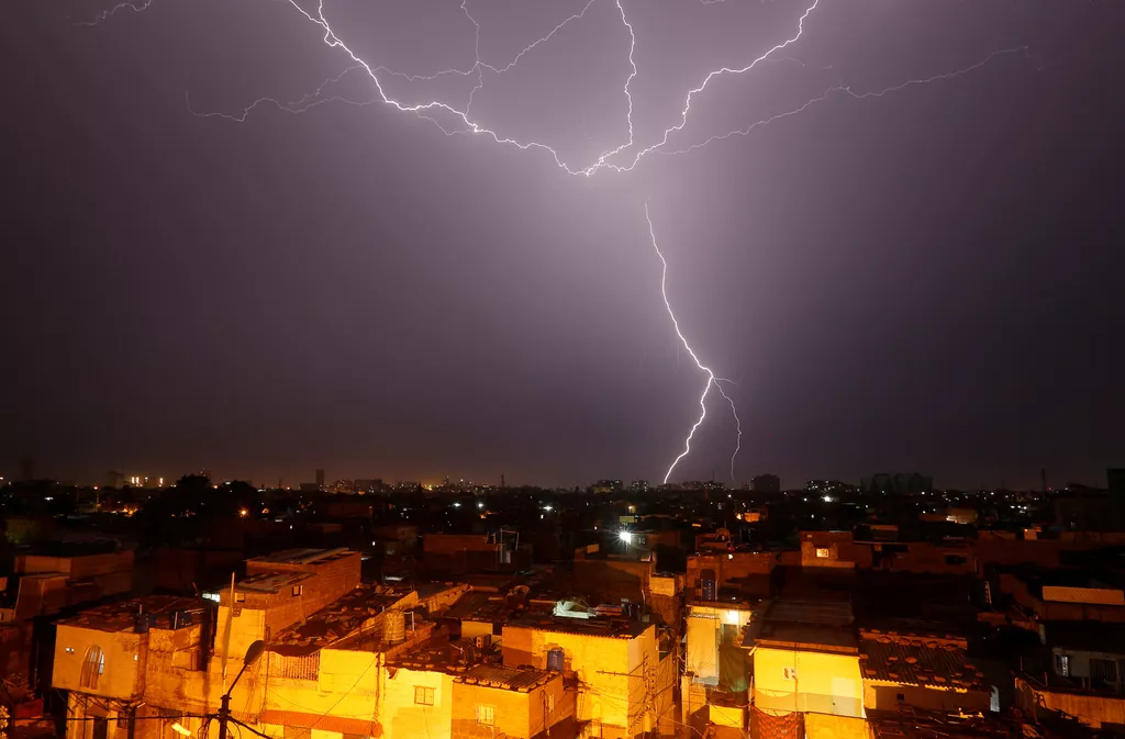 lightning bolt is seen above a residential neighbourhood during rain in karachi pakistan photo reuters