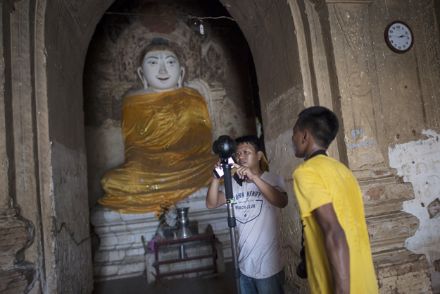 in this photograph taken on august 6 2017 nyi lin seck c and another member of his team set a 360 4k video camera with which they are documenting the crumbling 700 year old walls of the ancient city of bagan photo afp