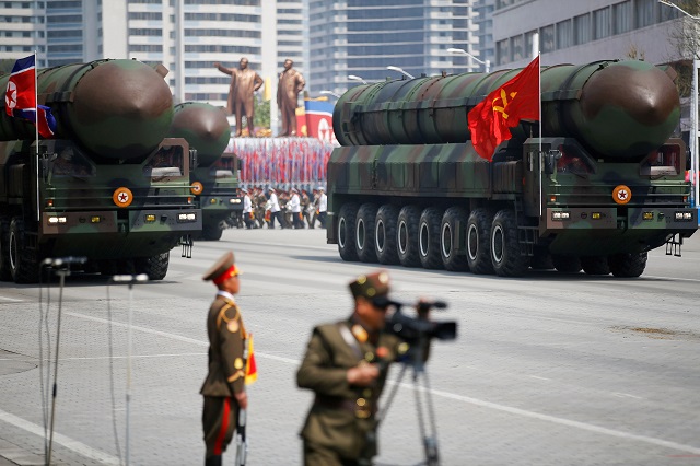 intercontinental ballistic missiles icbm are driven past the stand with north korean leader kim jong un and other high ranking officials during a military parade marking the 105th birth anniversary of country 039 s founding father kim il sung in pyongyang april 15 2017 the missiles themselves were shown for the first time inside a new kind of canister based launcher on saturday the trucks upon which they are mounted are originally designed to move lumber photo reuters