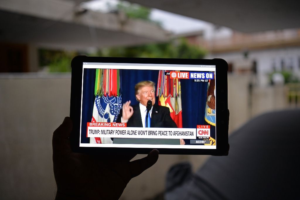 a pakistani resident watches a live broadcast of us president donald trump delivering his address photo afp